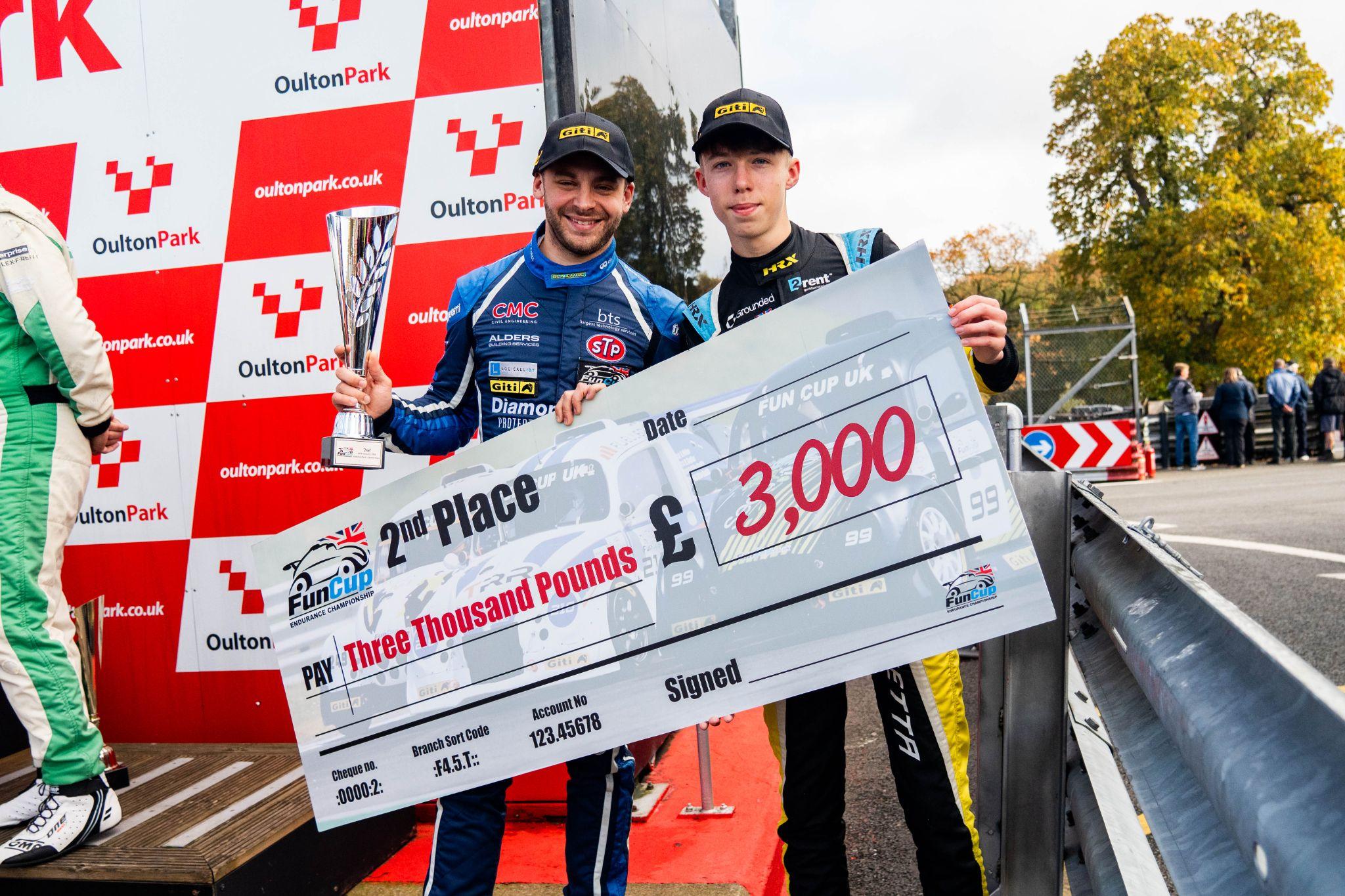 Year 12 student Charlie (right) accepting a cheque at the Fun Cup Endurance Championship in October